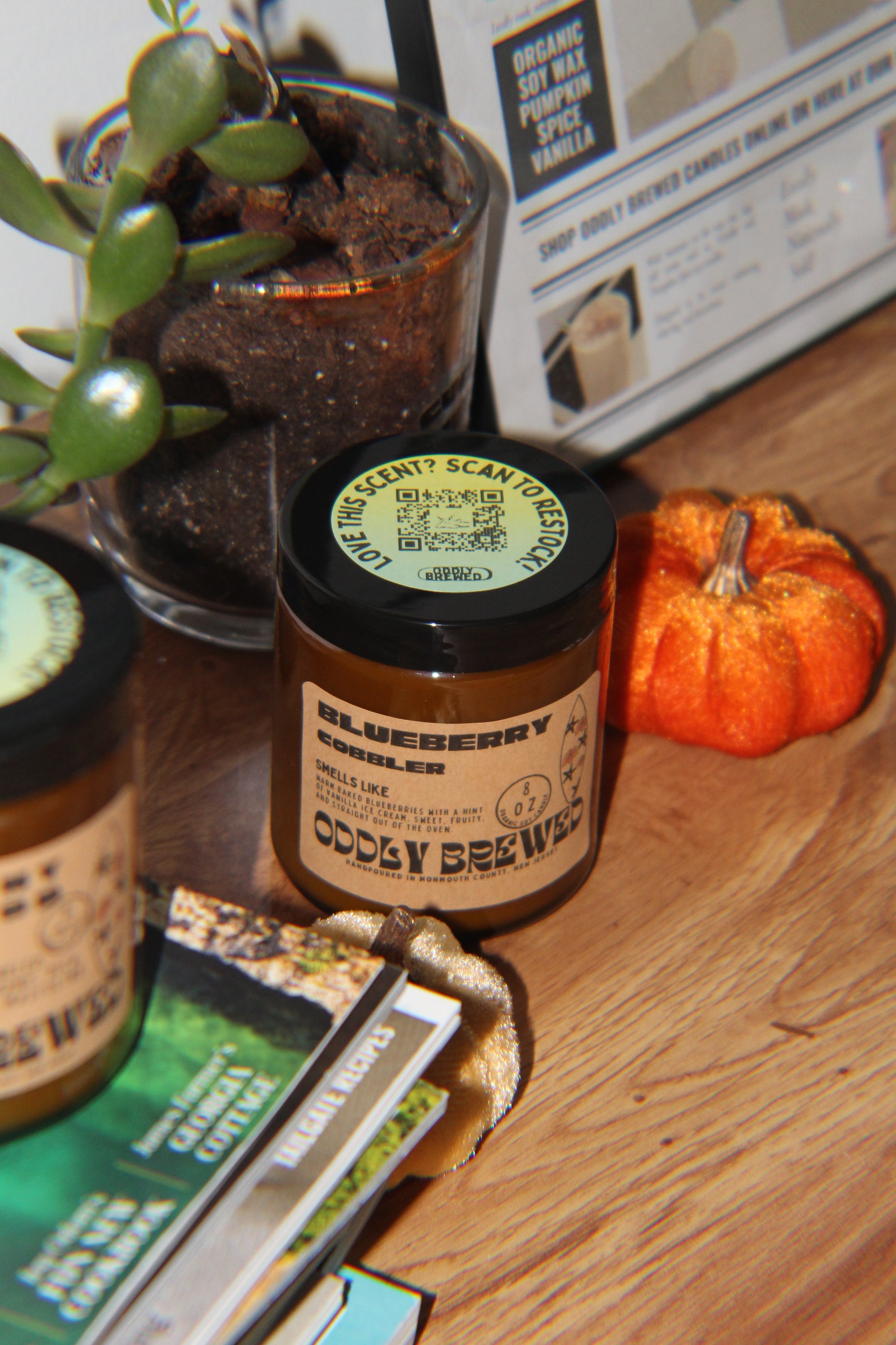 Bottle with a label on a wooden surface with a plant and newspaper in the background