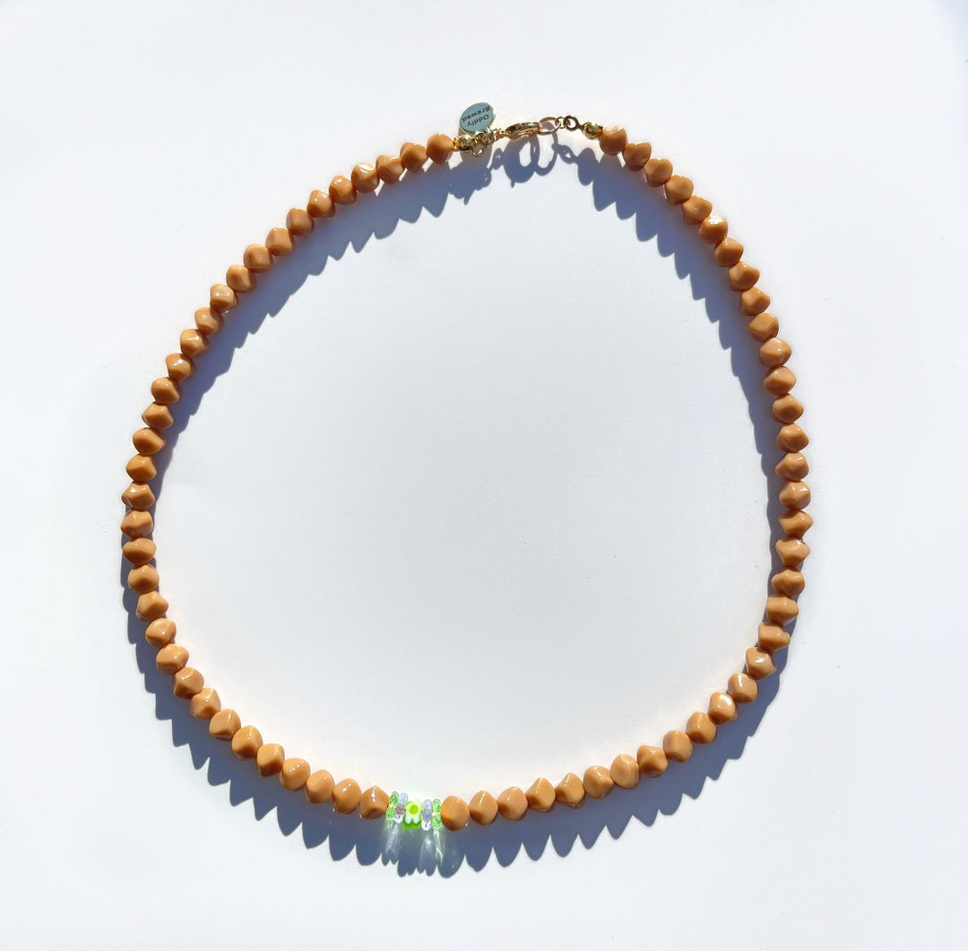The Chelsea coffee colored glass beaded necklace with mini flower bead