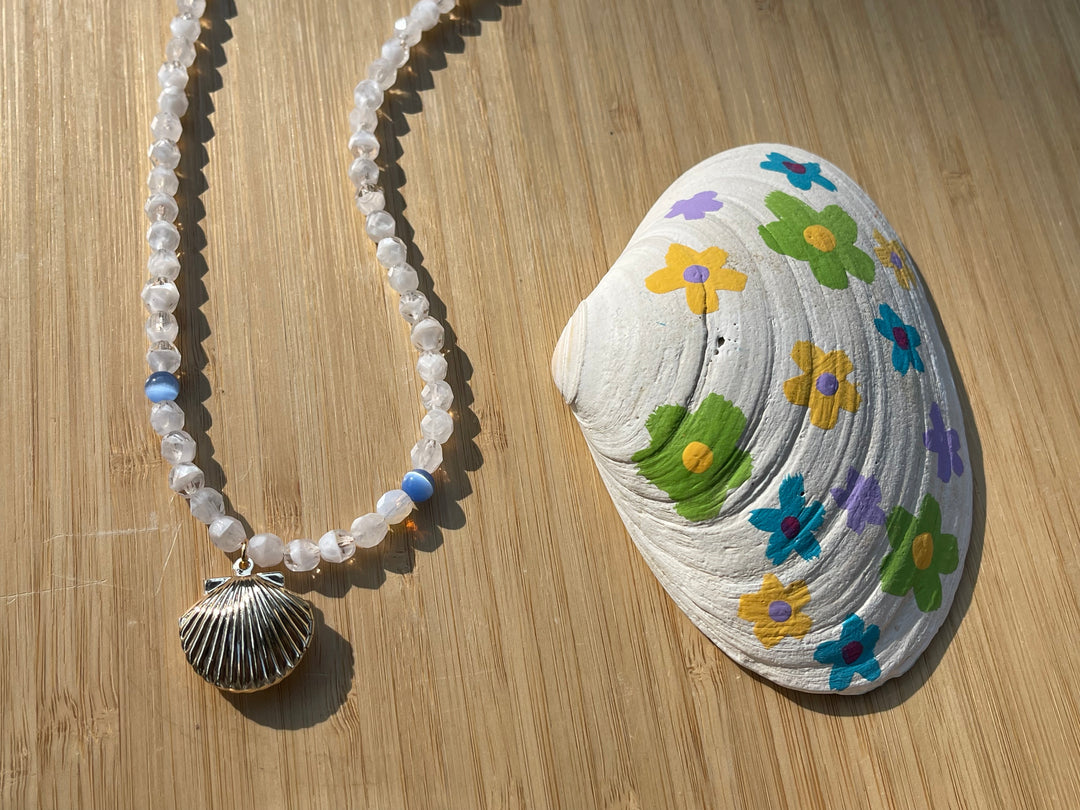 The Luke necklace next to a floral seashell